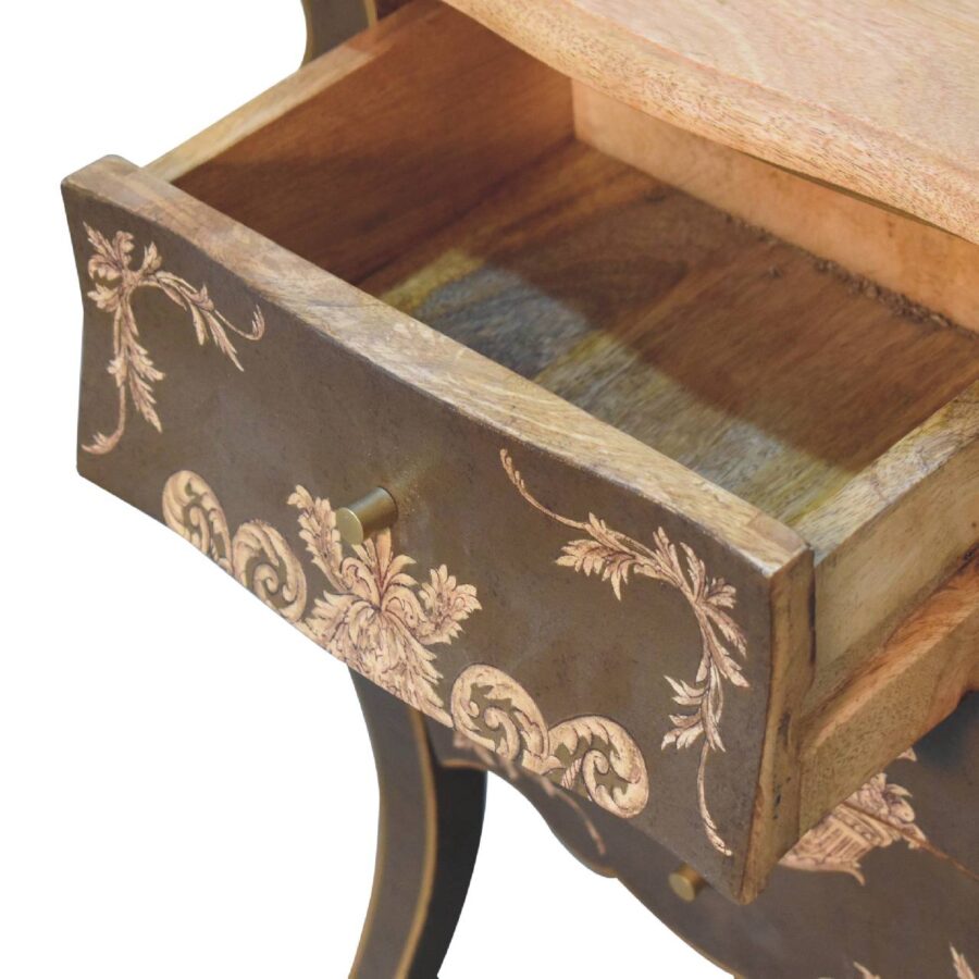 Open vintage drawer with floral pattern.