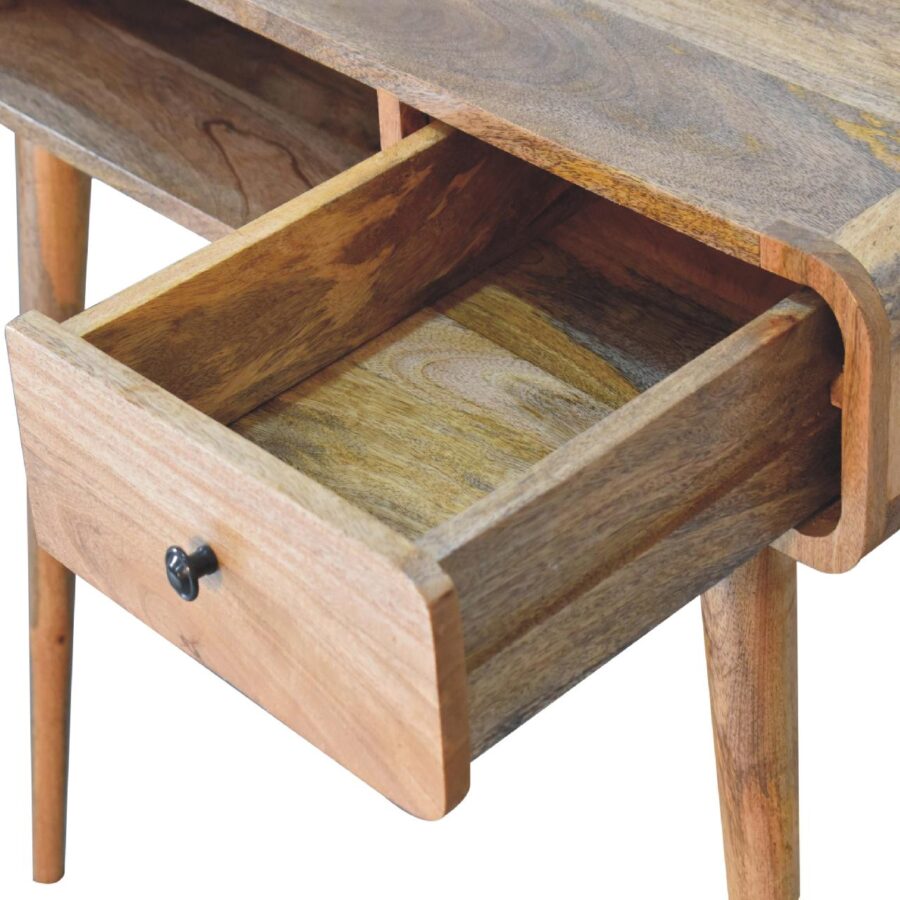 Wooden desk with open drawer, close-up view.