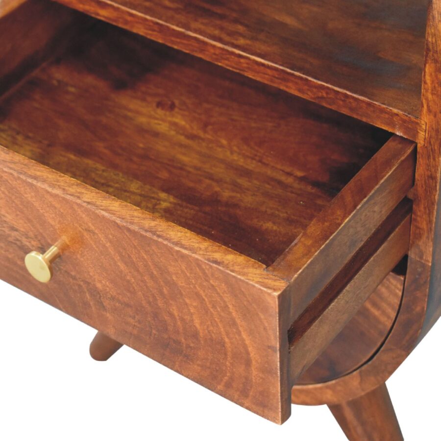 Open wooden drawer with brass handle.