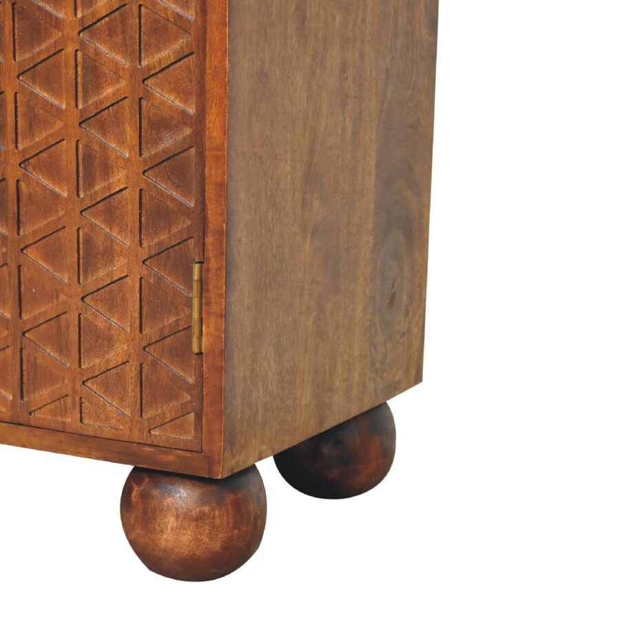 Carved wooden cabinet corner on spherical feet.