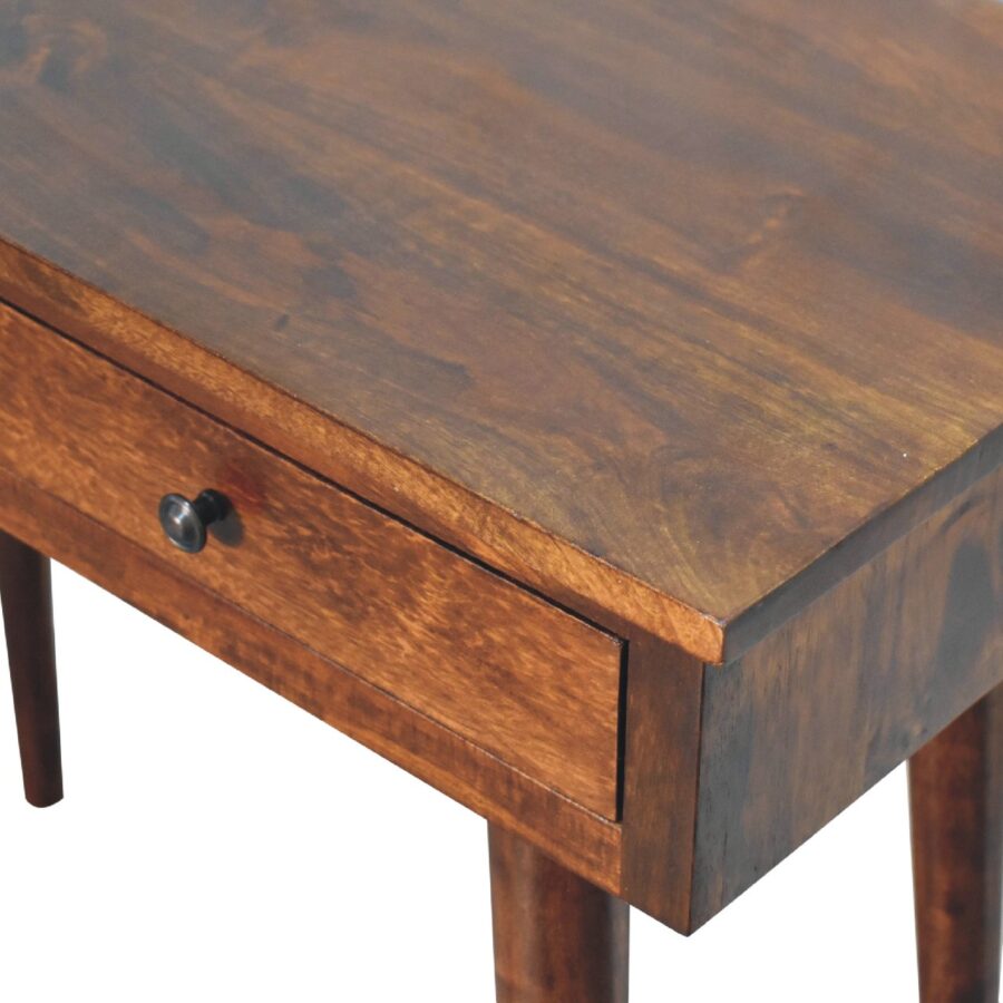 Wooden table with drawer detail.