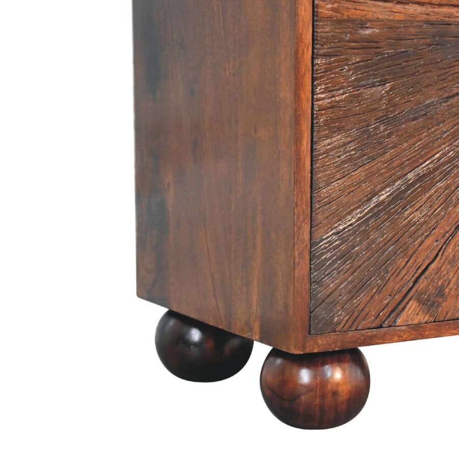 Wooden cabinet with round feet on white background.