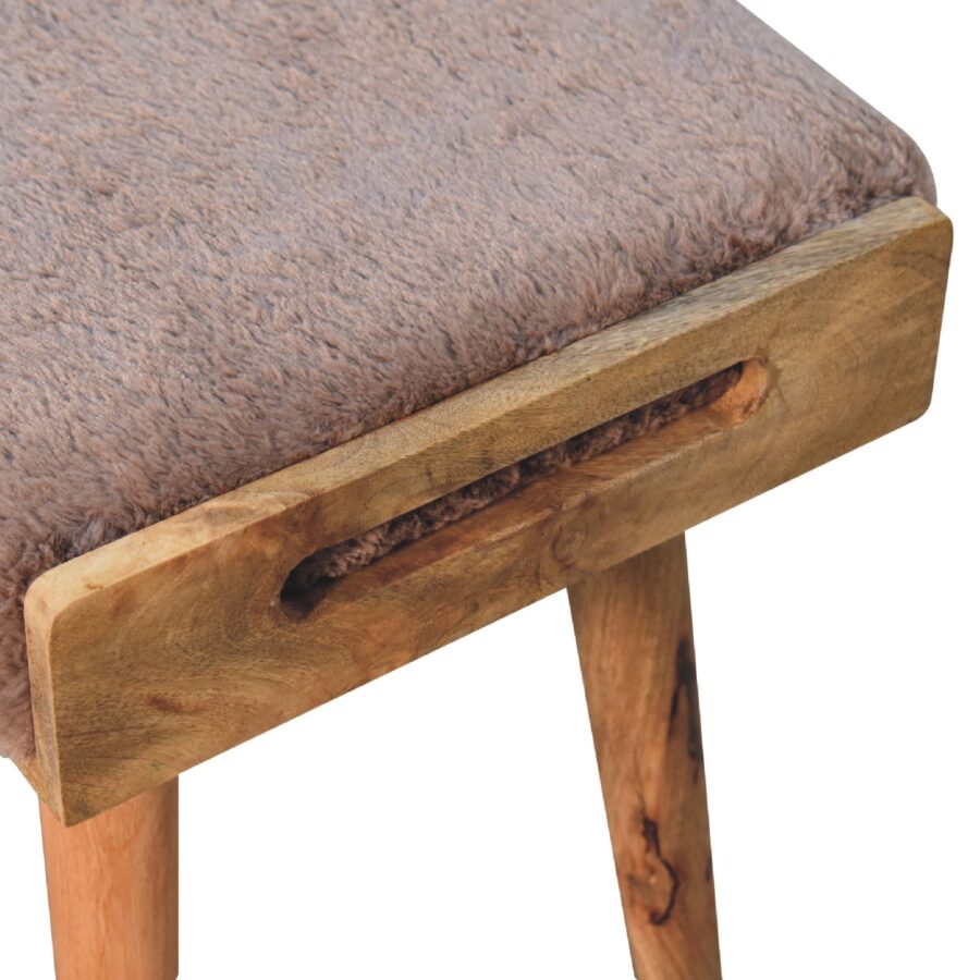 Wooden stool with plush brown top.