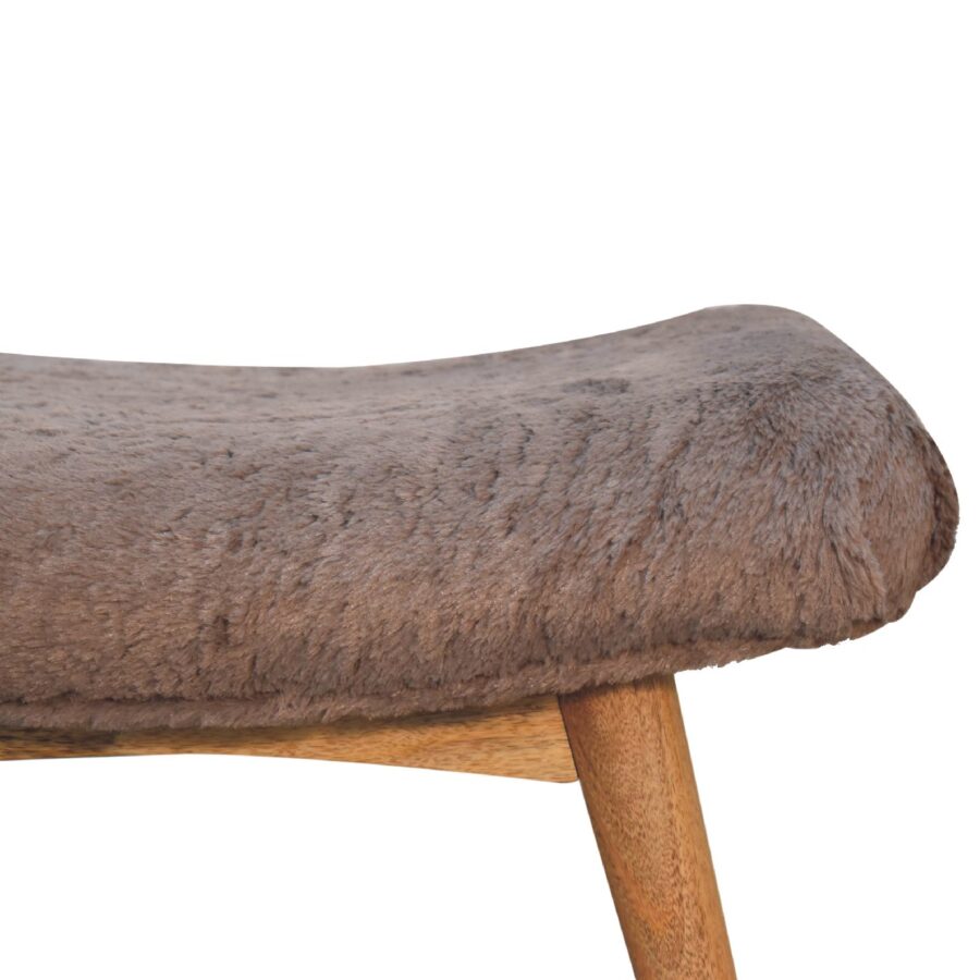 Furry upholstered stool on white background.