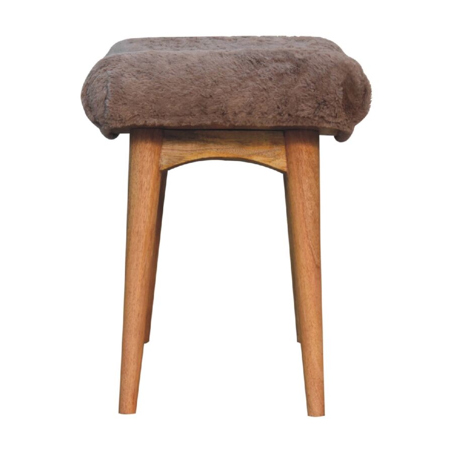 Brown furry stool on white background.