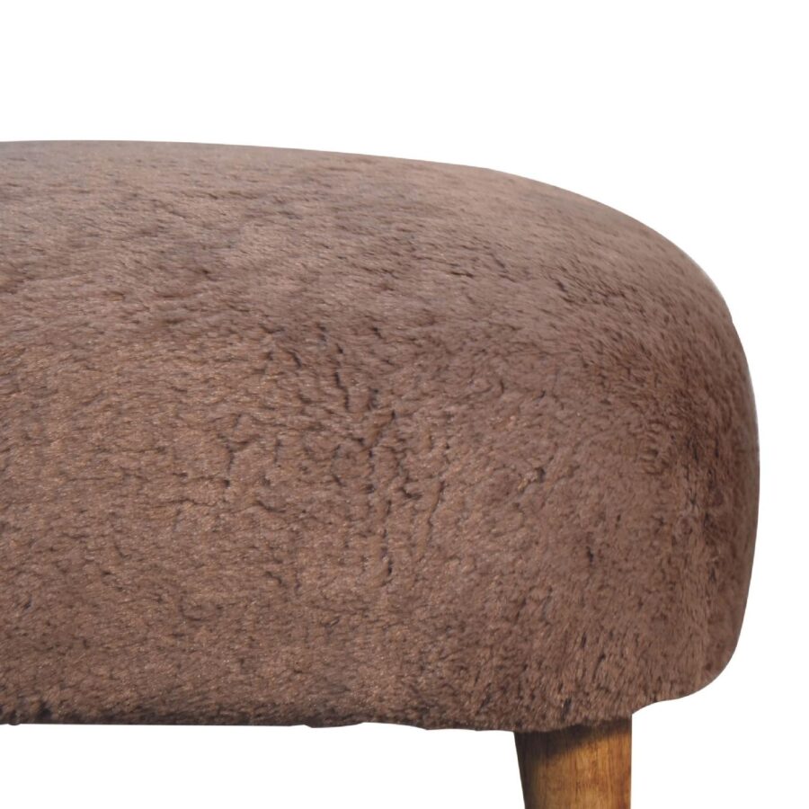 Close-up of brown upholstered stool top.