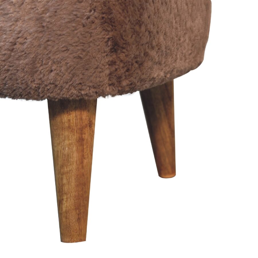 Furry stool with wooden legs.