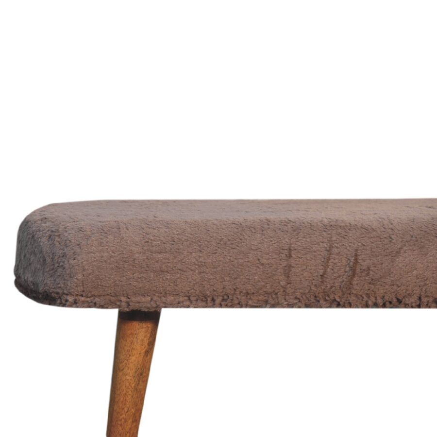Close-up of brown upholstered vintage table edge.
