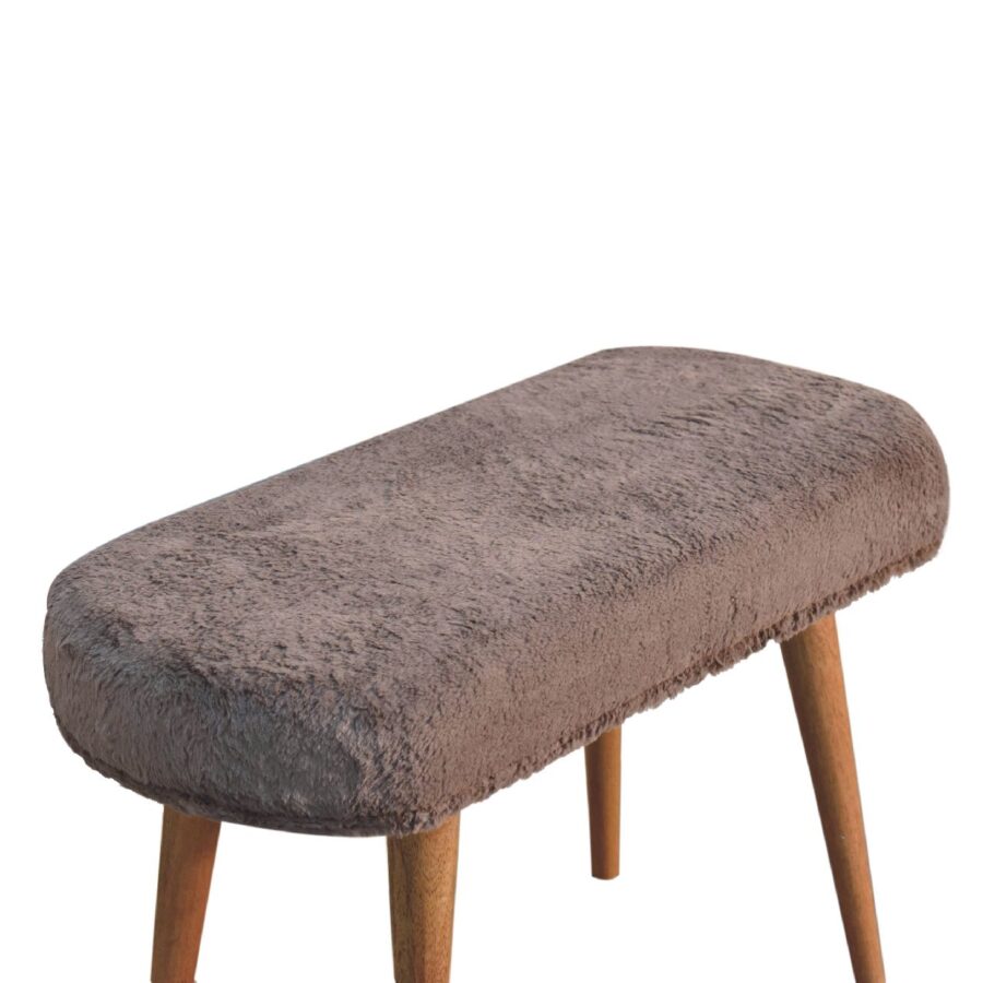 Brown upholstered bench with wooden legs.