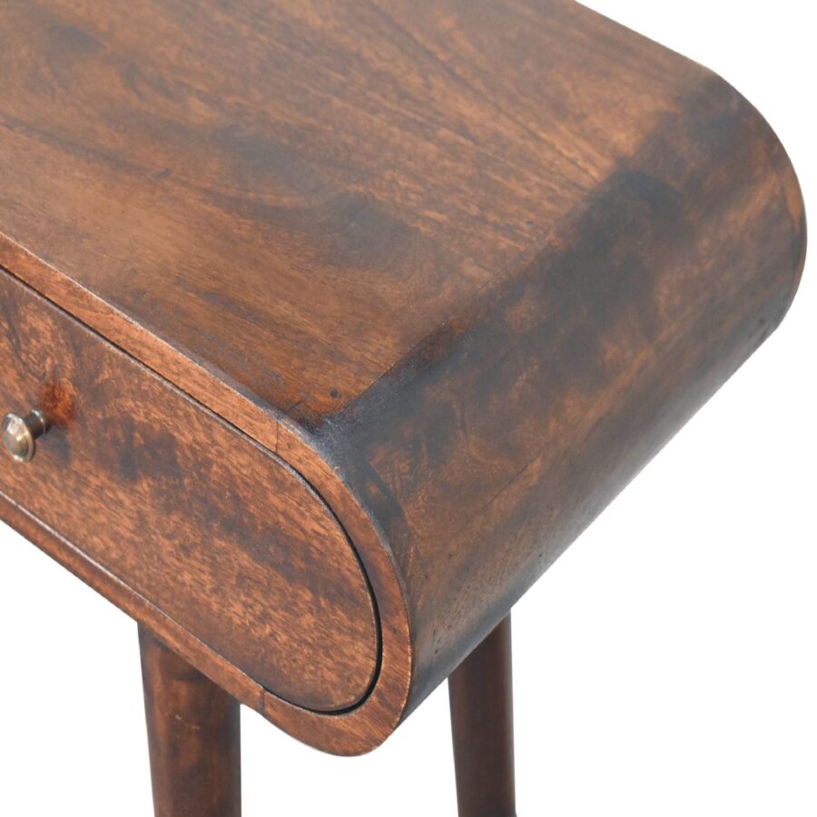 Antique wooden bedside table with drawer detail.