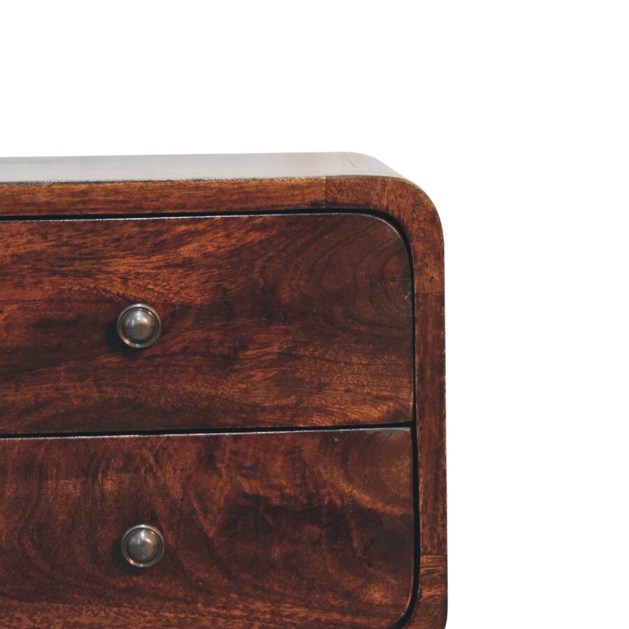 Wooden chest of drawers close-up on white background.