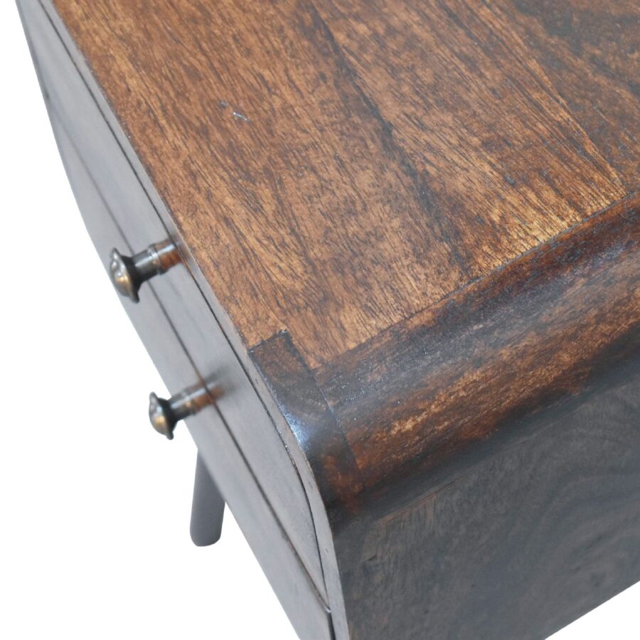 Vintage wooden desk corner with metal handles.