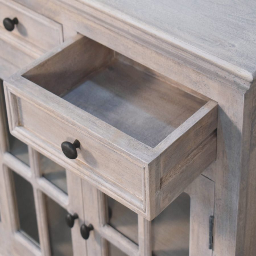 Open wooden drawer in vintage cabinet.
