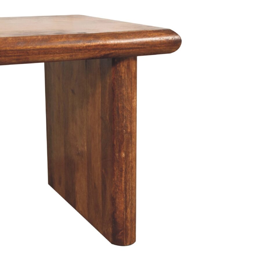 Solid wood brown dining table corner view.